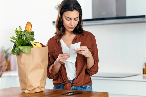 Shot Beautiful Young Woman Looking Grocery Receipt Kitche Home — Stock Photo, Image