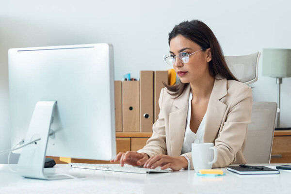 Shot of elegant smart business woman working with computer in the office