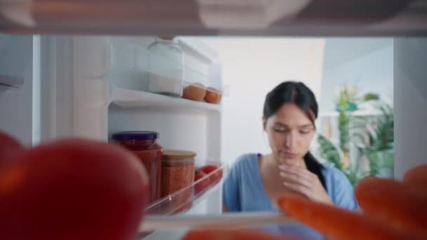 Відео Красивої Молодої Жінки Вагається Їсти Перед Холодильником Кухні — стокове відео