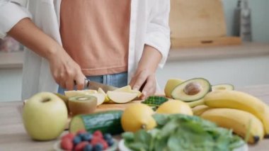 Güzellik videosu, evde mutfakta detoks suyu hazırlamak için pepino kesen bir kadın.