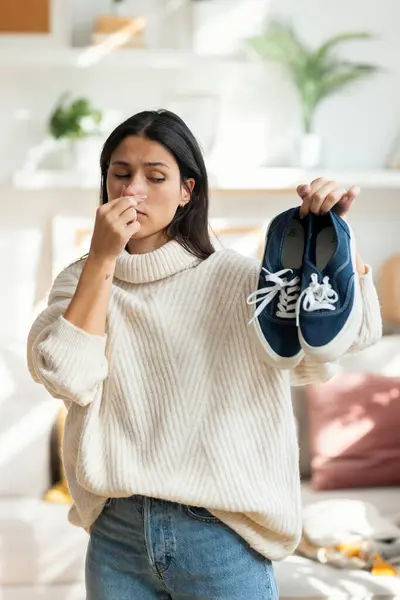 Shot Disgusted Beautiful Woman Holding Stinky Shoes Living Room Hom — Stock Photo, Image