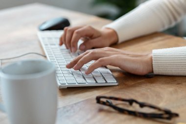 Close-up of business woman hands working with her laptop on a bar terrace