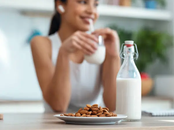 Shot Beautiful Woman Drinking Glass Milk While Standing Kitchen Morning Stok Gambar