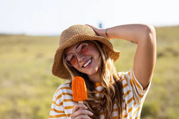 Shot Attractive Young Woman Eating Orange Popsicle Looking Camera Summer — Stock Photo, Image