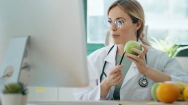 Beslenme danışmanlığında pasif danışmanlık yapmak için bilgisayarla video görüşmesi yapan güzel ve zeki bir beslenme uzmanı kadının videosu.