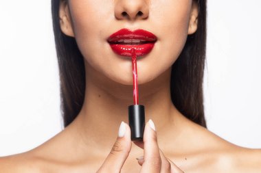 Close up of beautiful woman applying red lipstick on isolated white background clipart