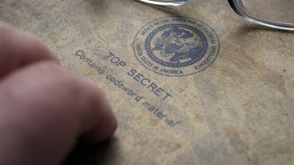 Finger tapping on top secret document