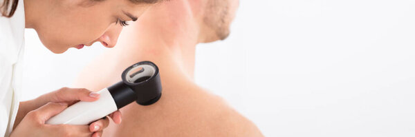 Dermatologist Testing Skin Using Dermatoscope. Dermatology Medical Doctor Examination