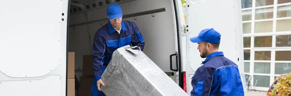 stock image Furniture Mover Unloading Truck. Relocation Delivery Load