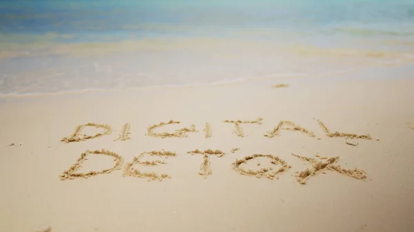 stock image Digital Detox Word Written On Sand Near The Sea At Beach