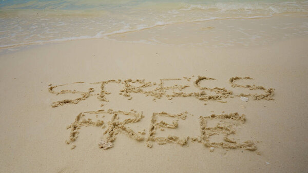 Stress Free Zone Written On Sand Near The Sea At Beach