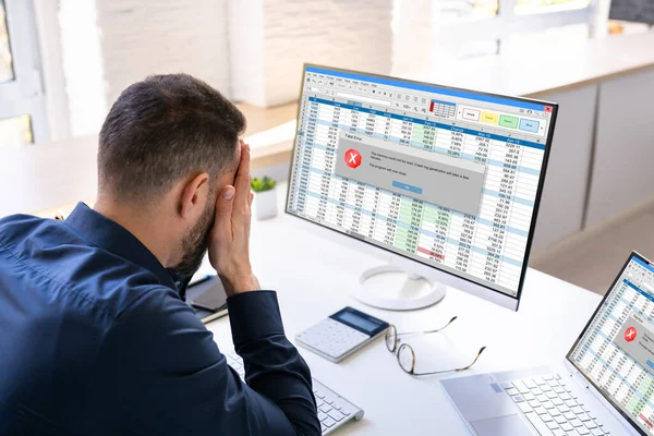 Worried Man At Computer With System Failure Screen At The Workplace
