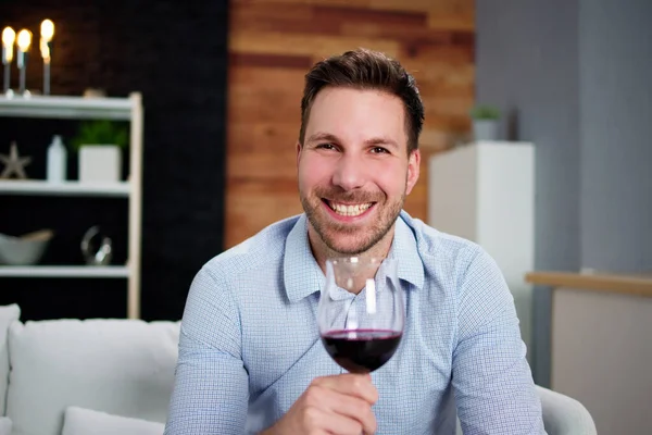Man Drinking Red Wine In Video Conference At Home