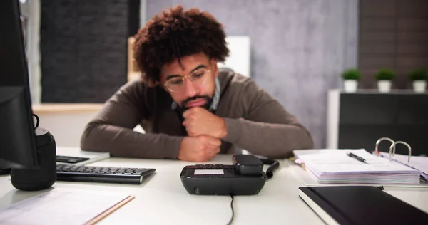 Waiting For Phone Call On Office Landline At Desk
