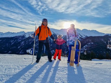 Family People In Austria In Winter Clothes With Kid