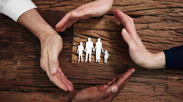 Group Of Hands Protecting Family Paper Cut Out