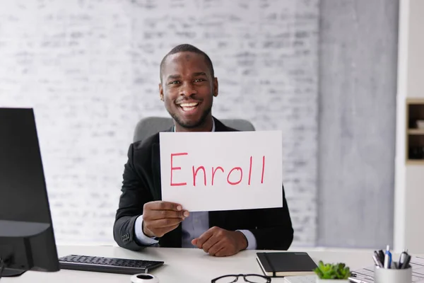 African American Man Holding Open Enrollment Registration Card — Stock Photo, Image