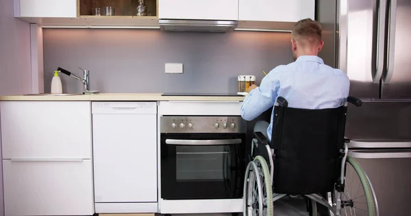 Man Disability Sitting Wheel Chair Preparing Food Kitchen — Foto de Stock