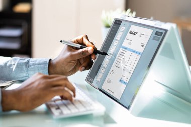 Business Accountant Using Electronic Bill On Laptop Computer