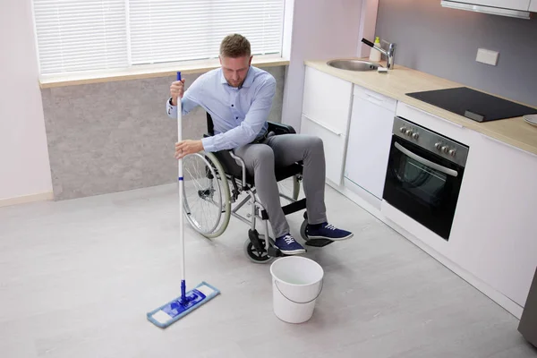 Person Disabilty Cleaning Kitchen Floor Using Mop — Zdjęcie stockowe