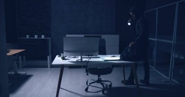Thief Stealing Computer From Office At Night