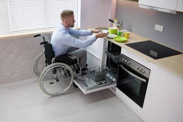 Person Disability Wheelchair Using Dishwasher Kitchen — Zdjęcie stockowe