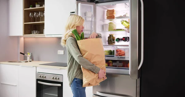 Mujer Con Bolsa Comestibles Pie Cerca Del Refrigerador Abierto Con — Foto de Stock