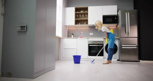 Ευτυχισμένη Γυναίκα Καθαρίζοντας Πάτωμα Σφουγγαρίστρα Στην Κουζίνα Στο Σπίτι — Φωτογραφία Αρχείου
