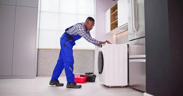 Young Man Overall Repairing Washing Machine — Stock Photo, Image