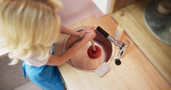 Cleaning Blocked Drain Clog In Kitchen Sink Using Plunger