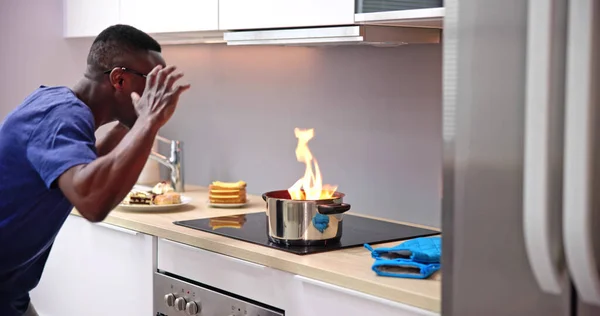 Kitchen Cooking Mistake And Fire Disaster. Man Shocked
