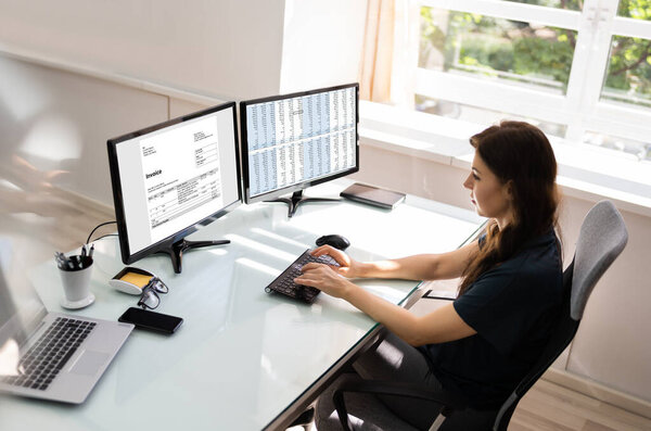 Accountant Using E Invoice Software At Computer In Office