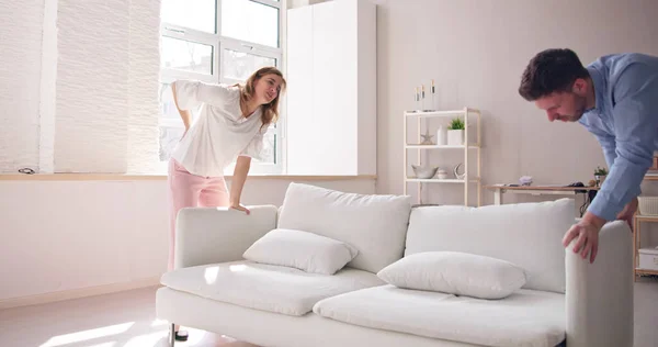 Person Lifting Heavy Furniture Couch Having Back Injury — Stock Photo, Image