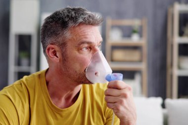 Asthma Patient Breathing Using Oxygen Mask And COPD Nebulizer clipart