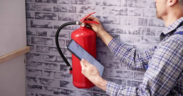 Worker Installing Fire Extinguisher Inspection Service Checking Security Label — Stock Photo, Image