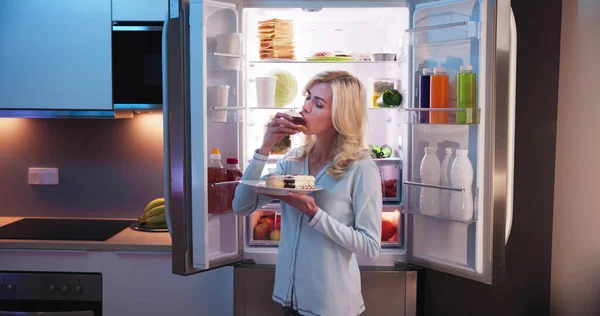Young Woman Eating Slice Sweet Cake Refrigerator — Stock Photo, Image
