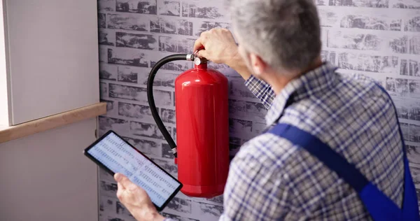 Worker Installing Fire Extinguisher Inspection Service Checking Security Label — Stock Photo, Image