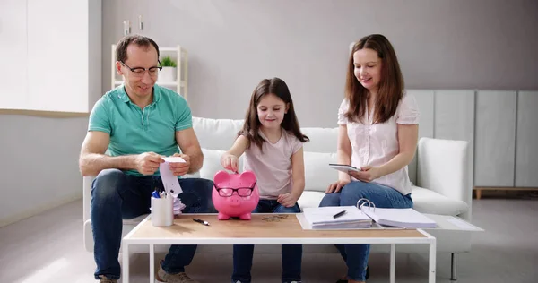 Familia Ahorrando Dinero Piggybank Casa — Foto de Stock
