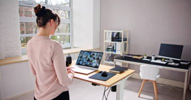 Video Conference Call Using Electric Adjustable Height Standing Desk clipart