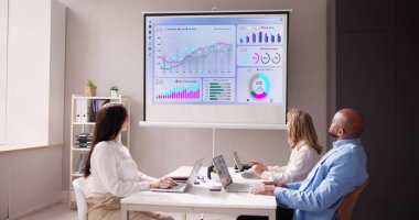 Businesspeople Looking At Businessman Giving Presentation In Meeting