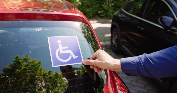 Driver Putting Wheelchair Sticker Sign Car Vehicle — Stock Photo, Image