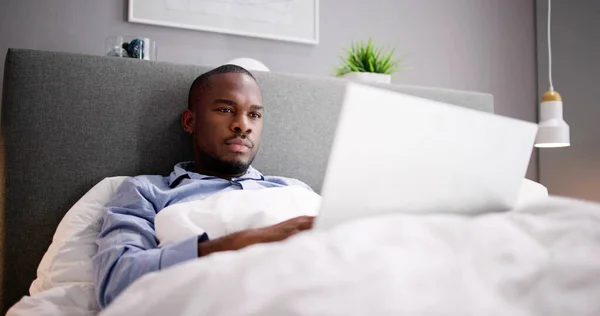 Happy Man Κάθεται Στο Κρεβάτι Χρησιμοποιώντας Laptop — Φωτογραφία Αρχείου