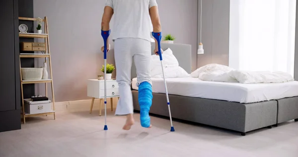stock image Man With Broken Leg After Accident Using Crutches