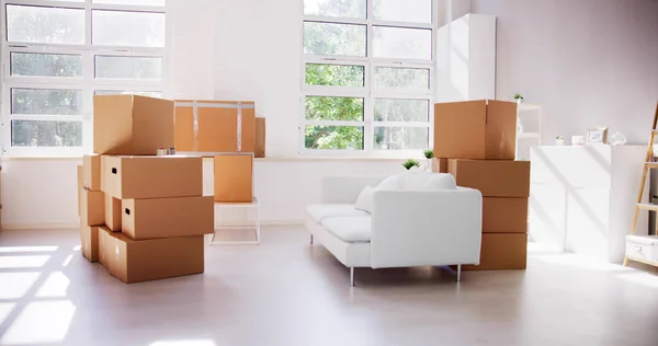 Residential Living Room Relocation. Moving Furniture And Delivery Boxes