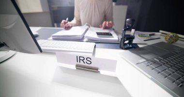 IRS Tax Audit Name Plate At Desk clipart