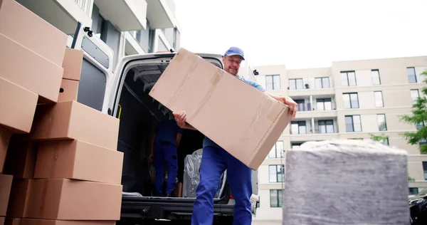 Two Young Male Movers Carrying Cardboard Box Truck — Stock Photo, Image