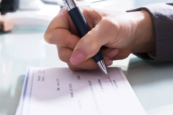 Close Businessperson Hand Signing Cheque Pen Office — Stock Photo, Image
