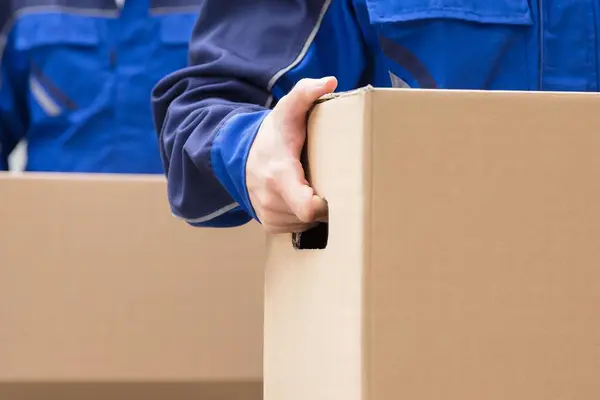 Close Two Mover Hand Uniform Carrying Cardboard Box — Stock Photo, Image