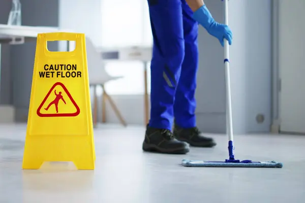 Caution: Wet Floor - Cleaning Janitor with Sign