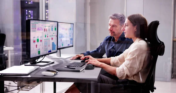 Two People Engaging in Engineering on Computer Screens